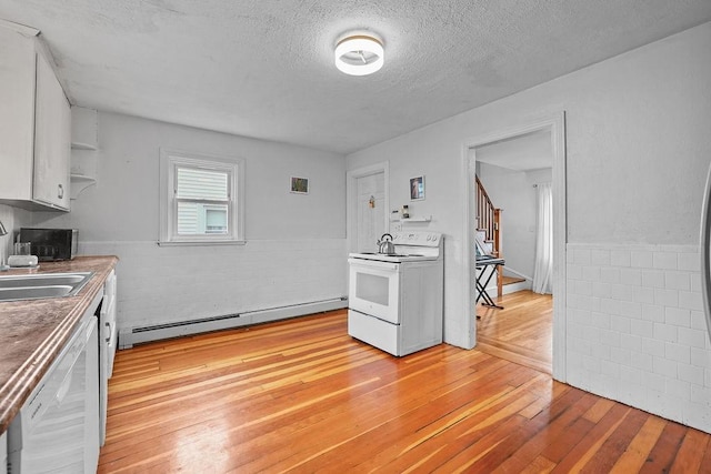 kitchen featuring a baseboard radiator, light wood-type flooring, white cabinets, white appliances, and a textured ceiling