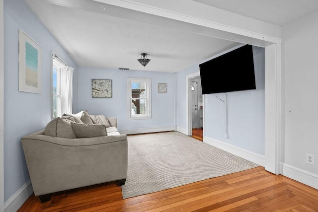 living room with hardwood / wood-style floors and a healthy amount of sunlight