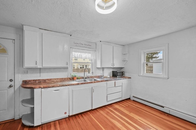 kitchen featuring sink, dishwasher, white cabinetry, and a baseboard radiator