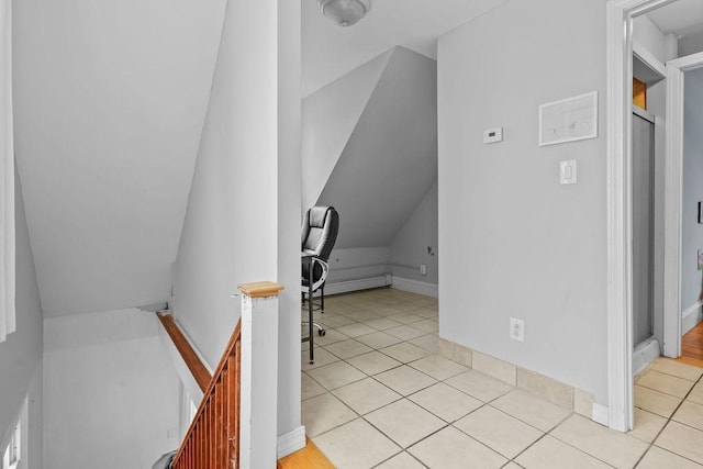 staircase with vaulted ceiling and tile patterned flooring