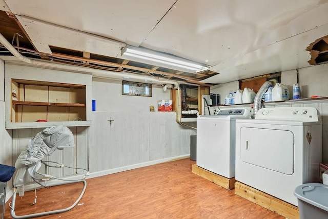 laundry room featuring independent washer and dryer and light wood-type flooring