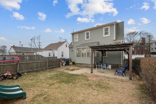 back of property with a patio, a pergola, and a lawn