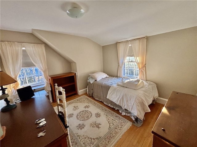 bedroom featuring vaulted ceiling and hardwood / wood-style floors