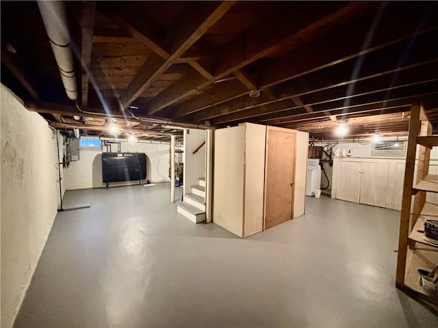 basement with washer / clothes dryer and electric panel