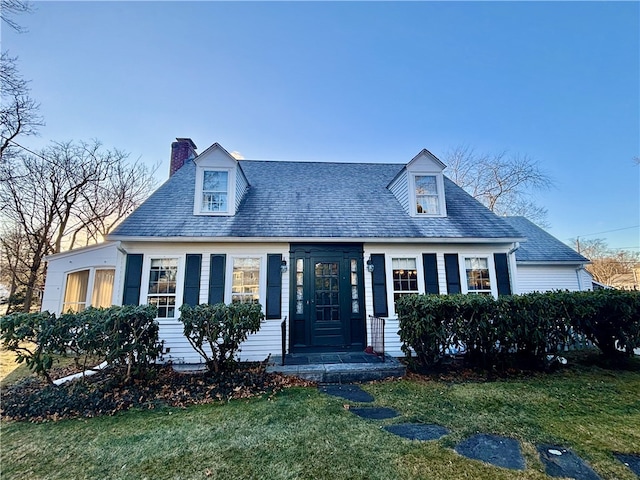 new england style home with a front yard