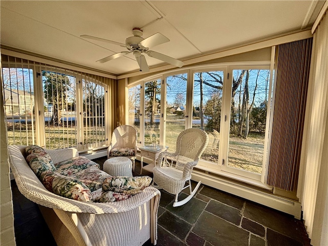 sunroom / solarium featuring ceiling fan