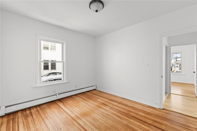 unfurnished room with light hardwood / wood-style floors and a baseboard radiator