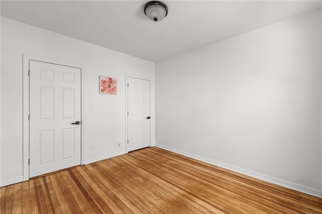 unfurnished bedroom featuring hardwood / wood-style flooring