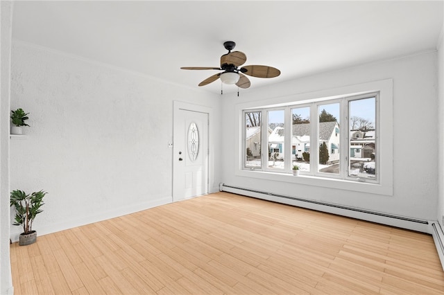 interior space featuring light wood-type flooring, ceiling fan, and baseboard heating