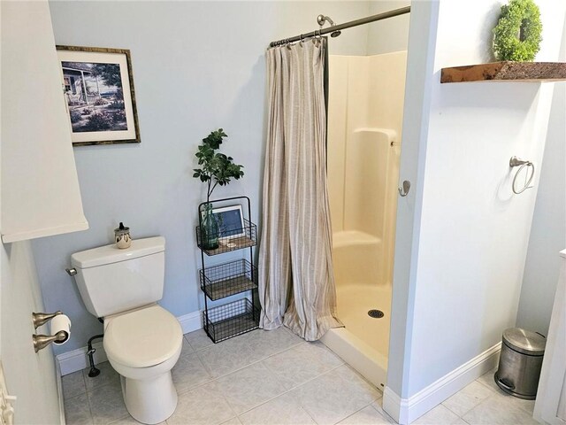 bathroom featuring tile patterned flooring, toilet, and a shower with shower curtain