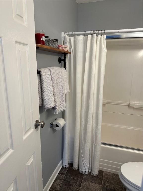 bathroom with toilet and shower / tub combo