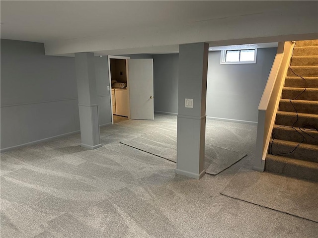 basement with light colored carpet and washer / clothes dryer