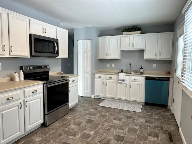 kitchen featuring sink, white cabinetry, and stainless steel appliances