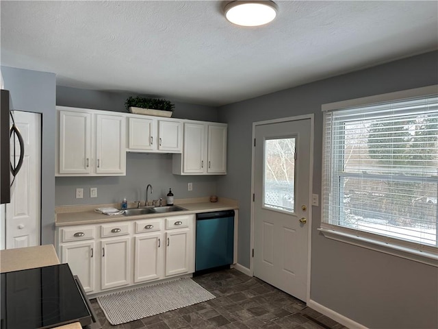 kitchen with sink, dishwasher, white cabinets, and range