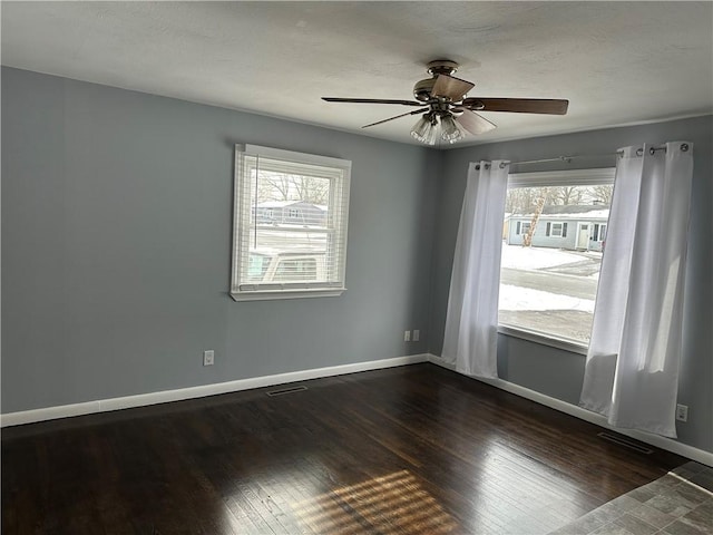 unfurnished room with ceiling fan and dark hardwood / wood-style floors