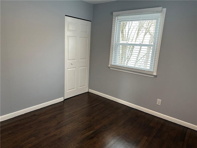 unfurnished room featuring dark hardwood / wood-style flooring