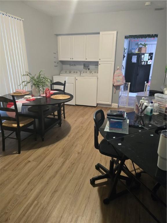 home office featuring washer and clothes dryer and light hardwood / wood-style flooring