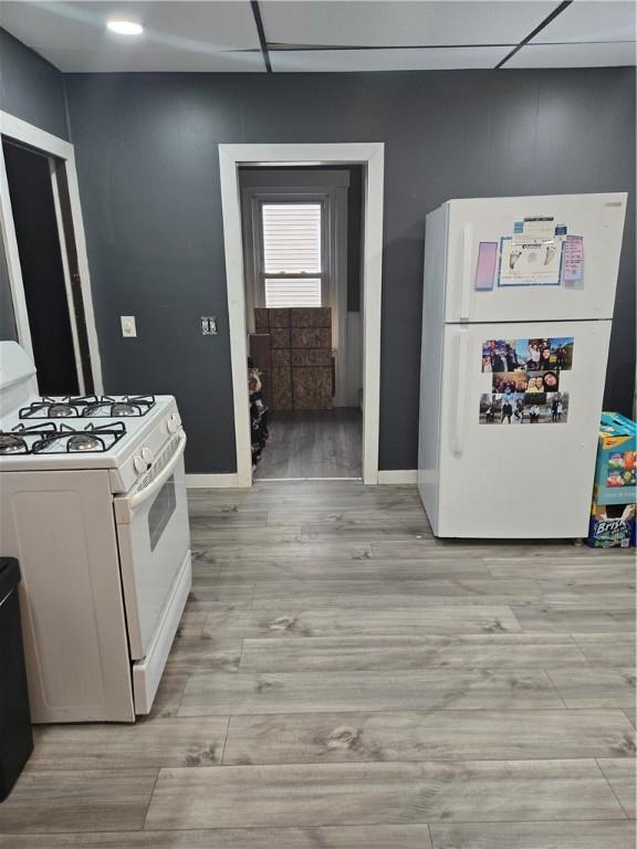 kitchen featuring white cabinetry and white appliances