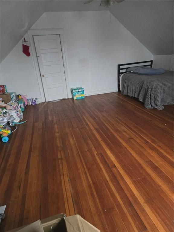 unfurnished bedroom featuring vaulted ceiling, ceiling fan, and dark hardwood / wood-style floors