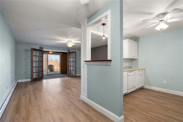 interior space featuring light wood-type flooring, ceiling fan, and a baseboard radiator