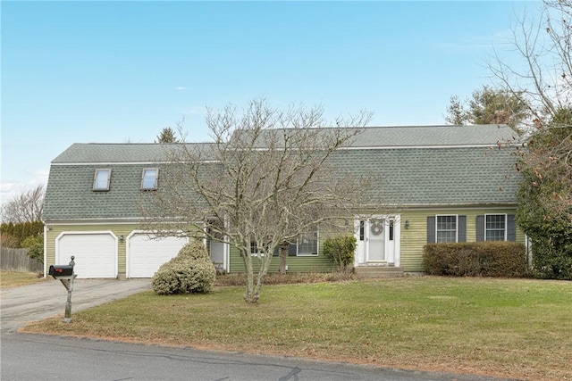 view of front of property featuring a garage and a front yard