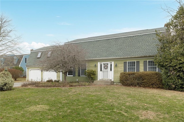 view of front facade with a garage and a front yard