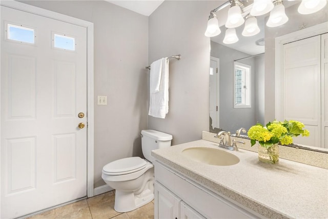 bathroom with tile patterned floors, vanity, and toilet