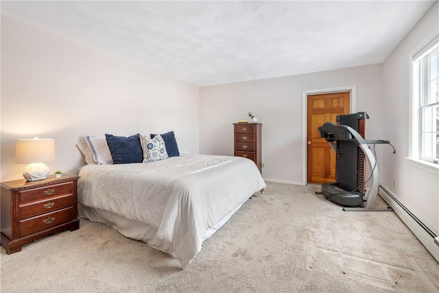 bedroom featuring light colored carpet and a baseboard heating unit