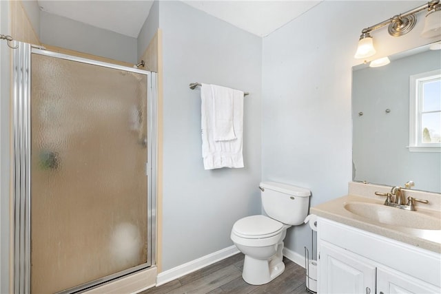 bathroom with vanity, toilet, an enclosed shower, and wood-type flooring