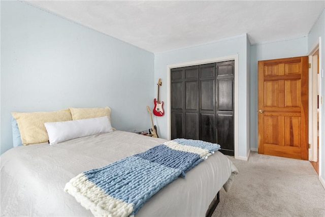 bedroom featuring a closet and light carpet