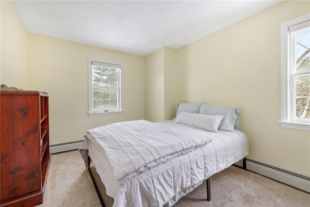 bedroom featuring baseboard heating and light carpet