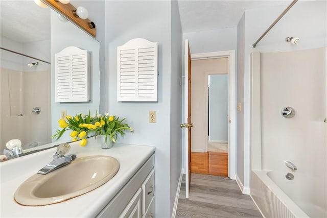 bathroom featuring hardwood / wood-style flooring, vanity, and shower / bathing tub combination