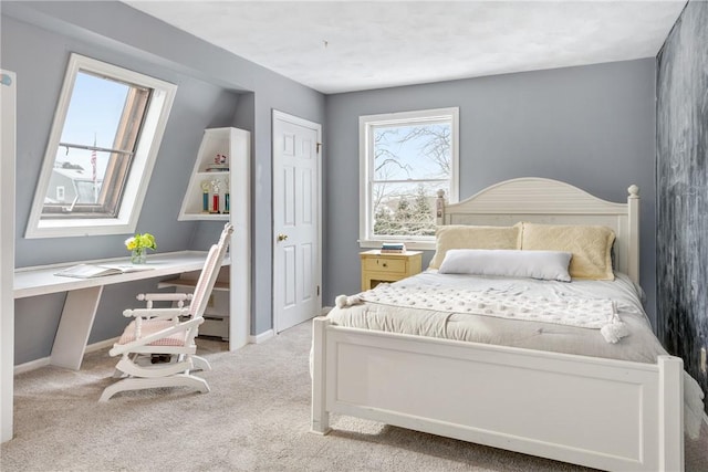 bedroom featuring built in desk, light colored carpet, and a baseboard radiator