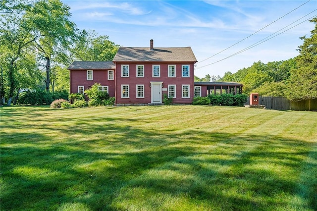 back of house featuring a yard