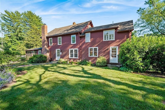 rear view of house with a lawn