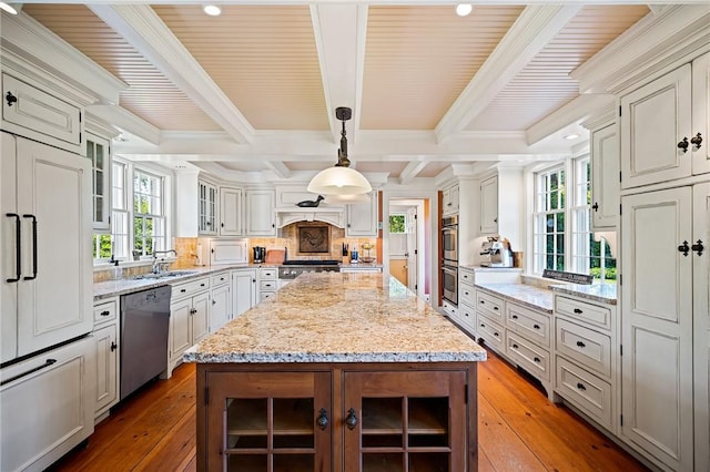 kitchen with decorative light fixtures, a center island, dark hardwood / wood-style floors, and stainless steel appliances