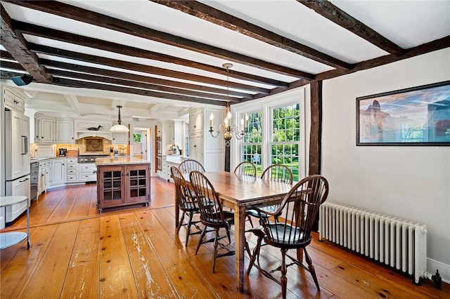 dining room featuring a chandelier, hardwood / wood-style flooring, radiator heating unit, and beam ceiling