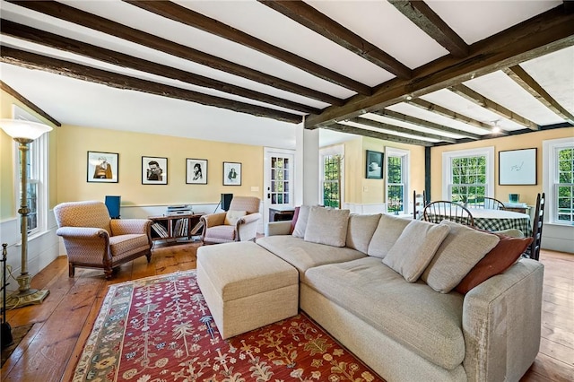 living room with hardwood / wood-style flooring and beam ceiling