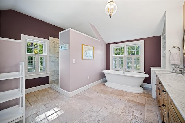 bathroom featuring vanity, lofted ceiling, and separate shower and tub