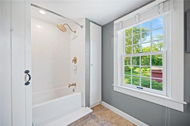 bathroom featuring tiled shower / bath combo and a healthy amount of sunlight