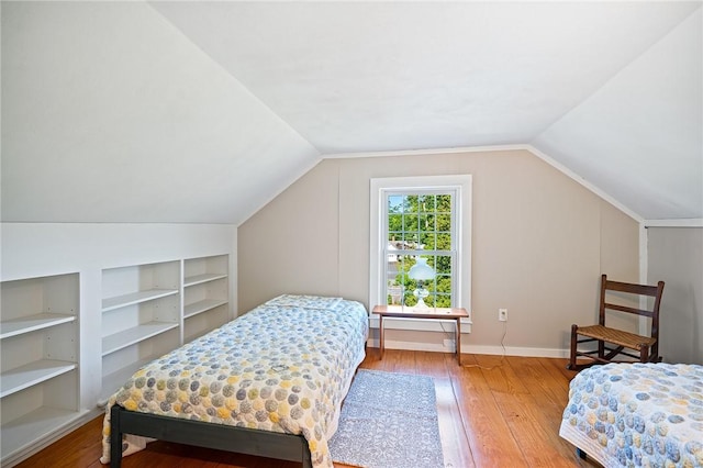 bedroom with hardwood / wood-style flooring and lofted ceiling