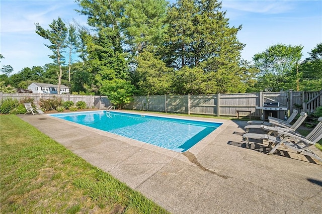 view of pool with a patio and a grill