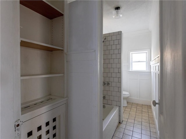 bathroom with toilet, tile patterned flooring, and ornamental molding