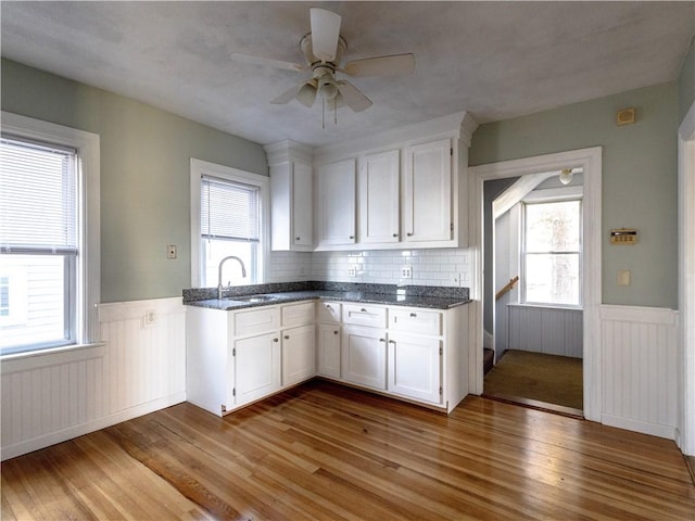 kitchen with sink, white cabinets, and light hardwood / wood-style floors