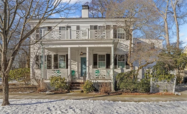 view of front of house featuring a porch and a balcony