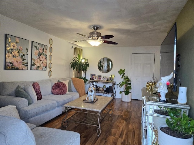 living room with ceiling fan and dark hardwood / wood-style floors