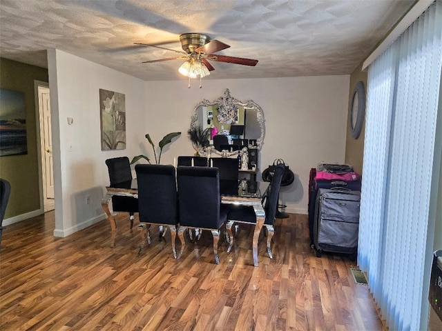 dining room with hardwood / wood-style flooring, ceiling fan, and a textured ceiling