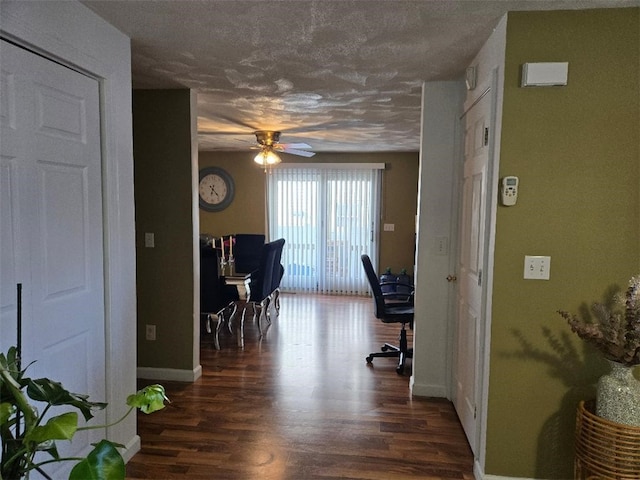 home office featuring a textured ceiling, dark hardwood / wood-style floors, and ceiling fan