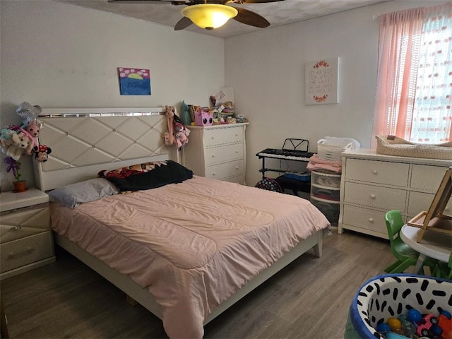 bedroom with ceiling fan and dark wood-type flooring