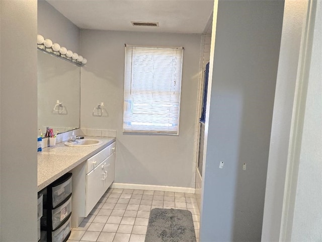 bathroom with shower / bath combination with glass door, vanity, and tile patterned flooring